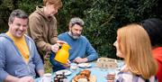 Group enjoying refreshments outside as part of the Mourne Dry Stone Wall Building experience