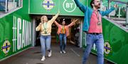 Group walking out of the players tunnel onto the pitch as part of a behind the scenes guided tour of Windsor Park with the Irish Football Association