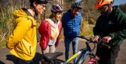 Group listening to their guide explaining the electric bikes on the Electric Escape experience with Corralea Adventure Centre