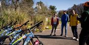 Group with their electric bikes listening to their guide on the Electric Escape experience with Corralea Adventure Centre