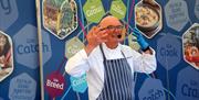 A local chef giving a cookery demonstration to the crowds