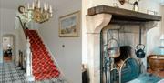 main staircase and large county fireplace in a reception room