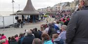 a large crowd of people watching a performance at The Crescent in Portstewart