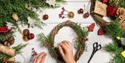 Image is of a Christmas wreath being created