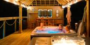 Large private decking area with luxury hot tub, lighting and firepit seating area