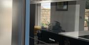 The south facing bespoke hand-painted kitchen with  Miele appliances