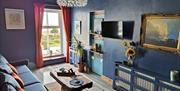 Living area full of bespoke furniture and art