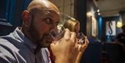 Guests taste mystery liquids during the Sensorium experience