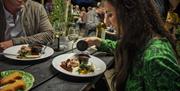 A guest lifts the lid off part of her freshly prepared meal at the Slemish Supper Club event