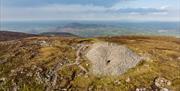 Birds eye view showing Slieve Gullion Cairn from top and surrounding landscape in the background.