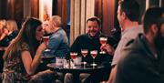 Table of 3 guests drinking cocktails