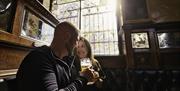 a couple enjoying drinks inside the bar.