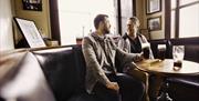 Two males sitting at table at The Maypole Bar