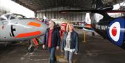 Couple walking through aircraft in bunker