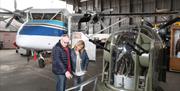 Couple looking at an artillery machine in bunker