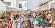 people browse market stalls at the Roe Valley Speciality Market