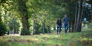 Image shows a woman and man walking in Wallace Park