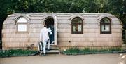 Image shows family entering a glamping pod