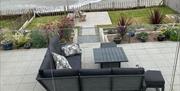 main patio with garden furniture with a view over the beach