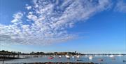 View over harbour, blue sky and boats moored