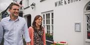 Couple walking outside the Wine & Brine restaurant