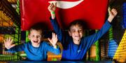 Young Boys cheer in the soft play area