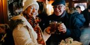 Man and woman enjoying a drink at the bar while on the Belfast Food Tour