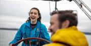 Guests enjoy a laugh during the Sailing in the Wake of Giants experience