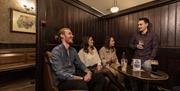 Group enjoying a drink in one of the snugs in Blakes of the Hollow