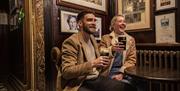 2 people enjoying a Guinness in Blakes of the Hollow