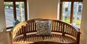A wooden bench and a patterned footstool in The Tangled Mermaid