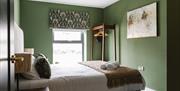 interior of bedroom at DB Stays 'The Cove' featuring a double bed and standalone clothes wrack