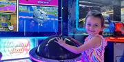Little Girl Enjoying The Arcade Games At Airtastic Lisburn