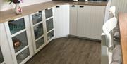 kitchen with fridge, microwave, coffee filter machine and french press.