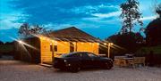 wooden lodge with car parked at front