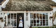 Tracey standing at the porch entrance of her Farmhouse Kitchen