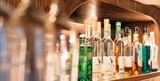 Bottles of alcohol lined on the shelf in the bar