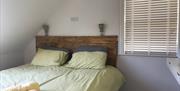 Superking sized bed with wall mounted dresser and mirror