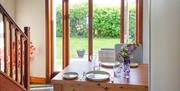 Eating area with doors opening to enclosed back garden