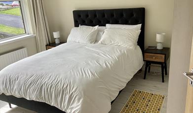 double bed with bedside lamp tables