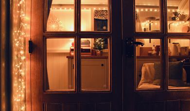 Peatlands shepherd hut doors with festive decoration.