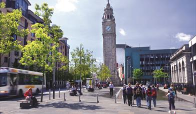 The Albert clock rising above the surrounding busy Belfast city area.