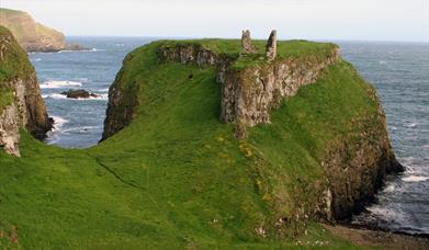 the ruins of Dunseverick Castle on a cliff along the Causeway Road