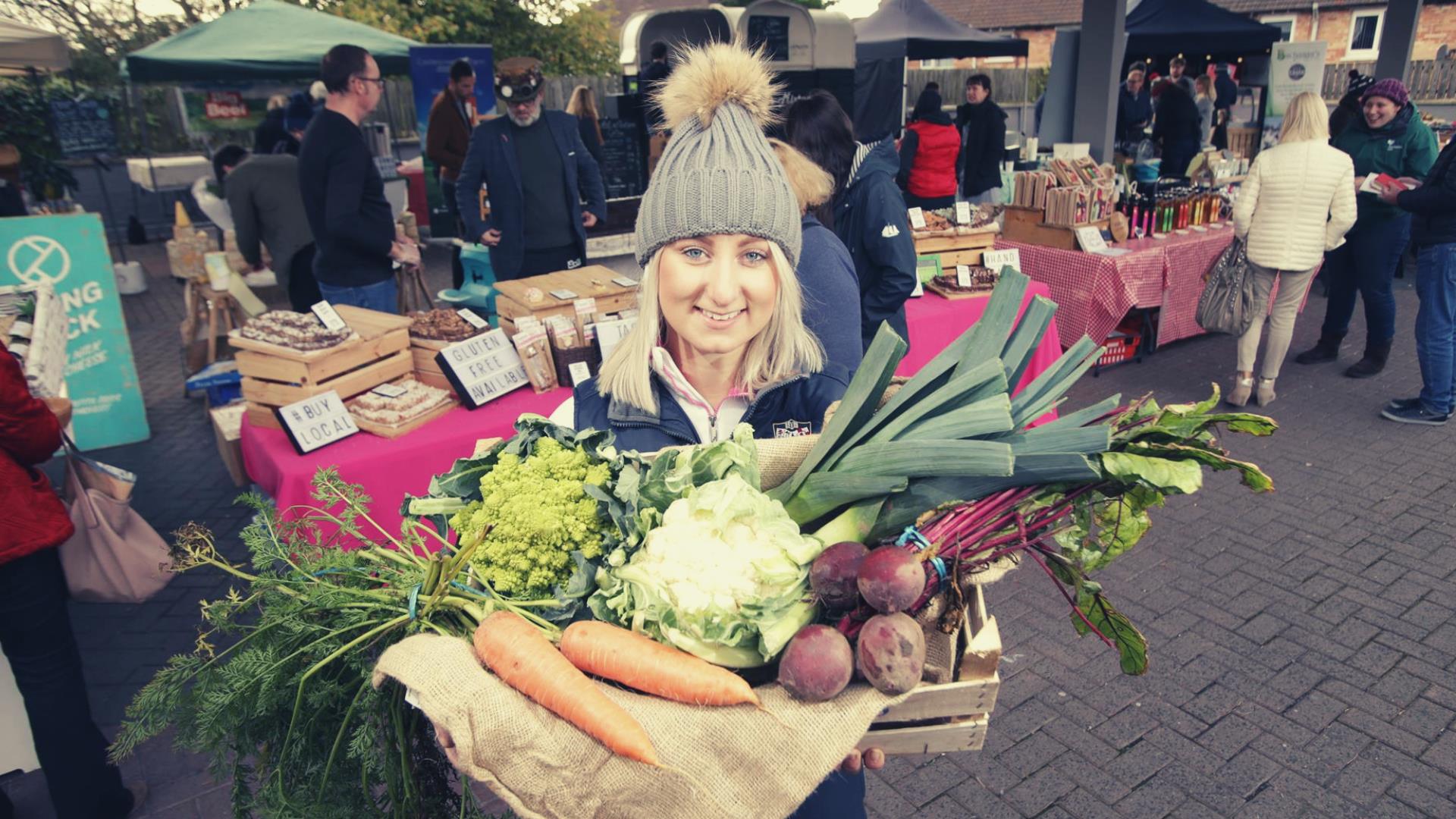 Image of Ashleigh from Cherry Valley Farm - a vegetable farm with market goings-on in the background