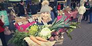 Image of Ashleigh from Cherry Valley Farm - a vegetable farm with market goings-on in the background
