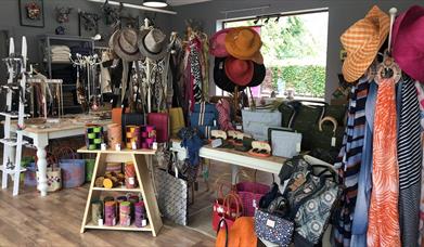 Shop with displays of hats, scarves, jewellery, handbags and more
