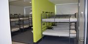 Image is of a dormitory with 4 sets of bunk beds