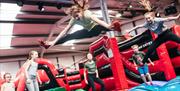 Group of children jumping in the air at the Airtastic Inflata Park
