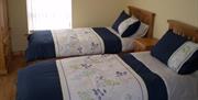 Two single beds with navy and floral bedding