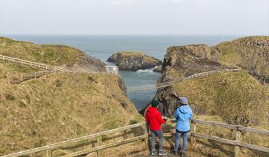Two visitors admiring the views at Carrick-a-Rede
